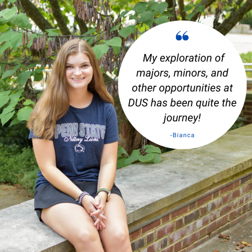 Light-skinned college-aged female wearing a blue Penn State t-shirt sitting on a stone wall. Text in a quote bubble read: My exploration of majors, minors, and other opportunities at DUS has been quite the journey!