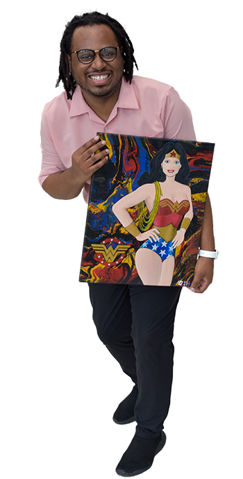 Full body image of Gerald Murphy, Jr., black man smiling holding a painting of Wonder Woman.