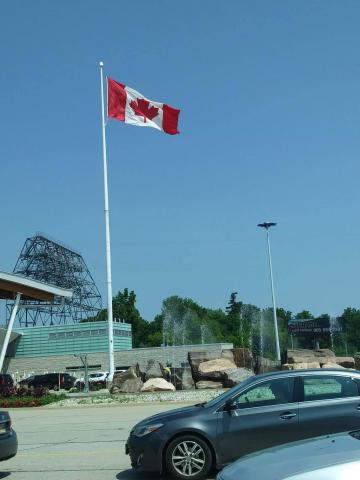 Canadian flag flying above the border between the U.S. and Canada.