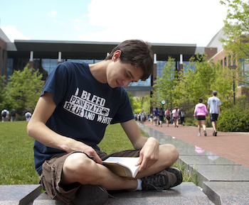 Student studying next to Thomas Building at University Park